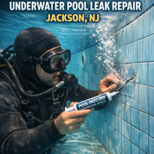 Professional diver performing underwater pool leak repair with a pool patcher in a residential pool in Jackson, NJ.